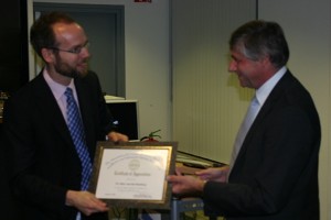 Jaap van der Lelie (r), chapter secretary, presents a certificate of appreciation to September guest speaker Marc van den Homberg, manager, defense market, the Netherlands Organization for Applied Scientific Research-Information and Communications Technology (TNO-ICT), for his presentation.
